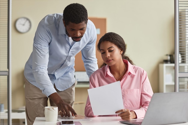 Photo coworkers looking at document at office workplace