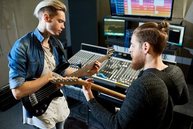 Coworking musicians in recording studio