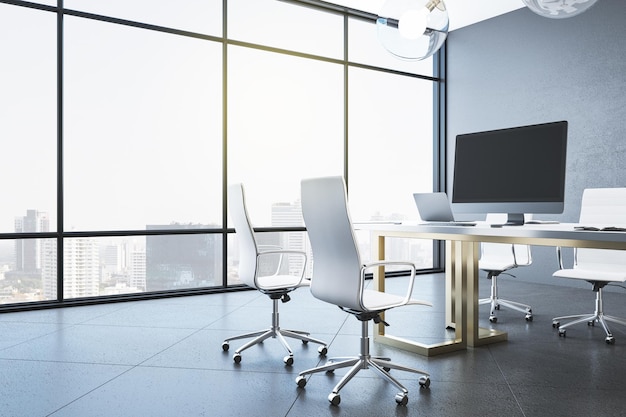 Coworking office interior with blank computers screen