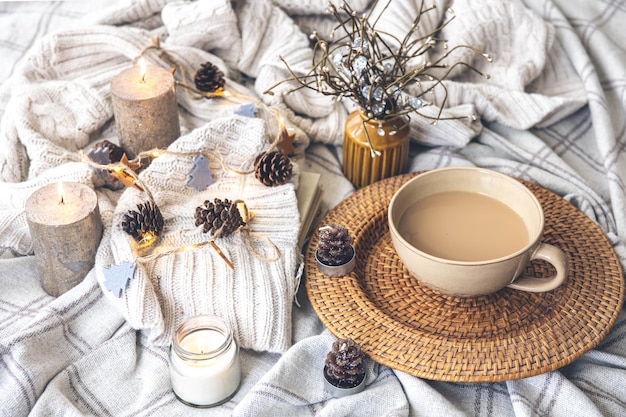 Cozy autumn composition with a big cup of coffee in bed