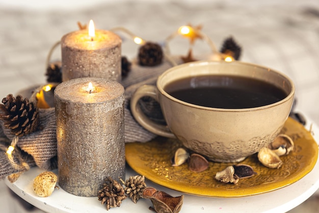 Cozy autumn composition with a cup of tea and decorative details