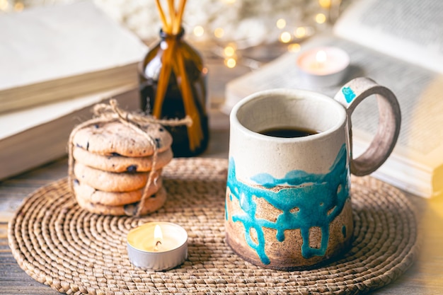 Cozy autumn composition with a handmade cup closeup