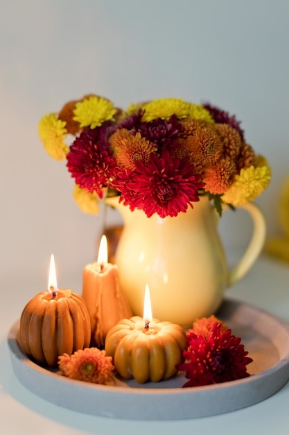 Cozy autumn mood Flowers and candles