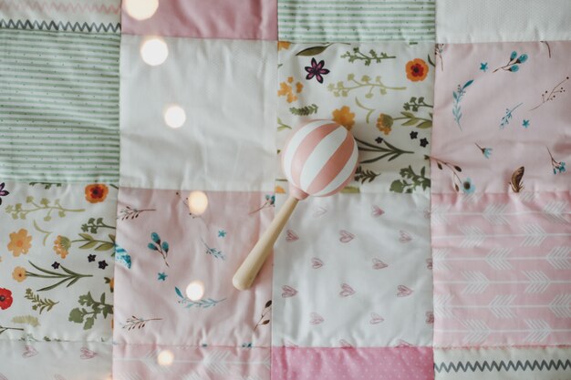 cozy baby cot with pink patchwork blanket