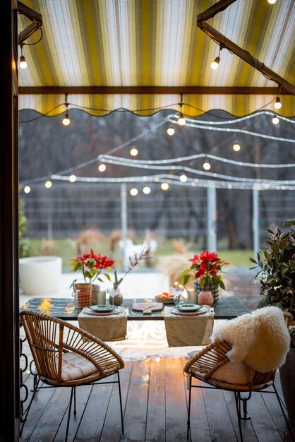 Cozy backyard with decorated and served table for a dinner