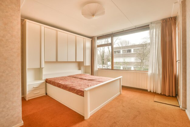 Cozy bedroom with a bed on a carpet floor