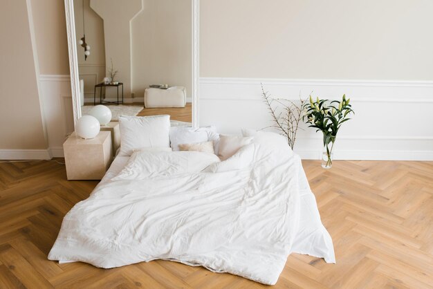 Cozy bright bedroom in warm shades in scandinavian style home\
interior