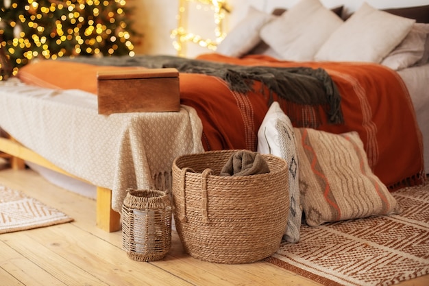 Cozy christmas bedroom scandinavian interior with bed pillows and Xmas decor