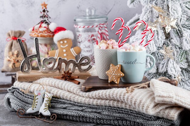 Cozy christmas composition with a cup and cookies. Hot chocolate with marshmallow.