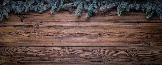 Cozy christmas copy space background with spruce branches and barn wood