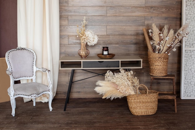 Photo cozy design office room home wooden table armchair baskets with dried flowers and pampas grass