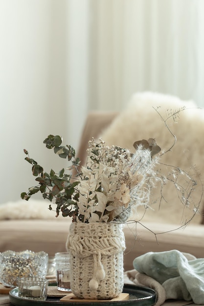 Cozy home background with dried flowers in a vase in the interior