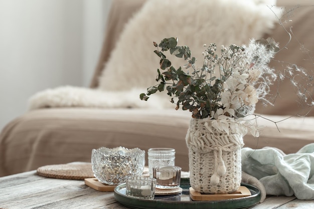 Cozy home background with dried flowers in a vase in the interior