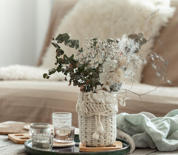 Cozy home background with dried flowers in a vase in the interior