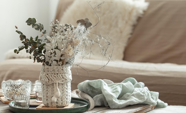 Cozy home background with dried flowers in a vase in the interior