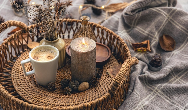 Cozy home composition with a cup of coffee a candle and decorative details