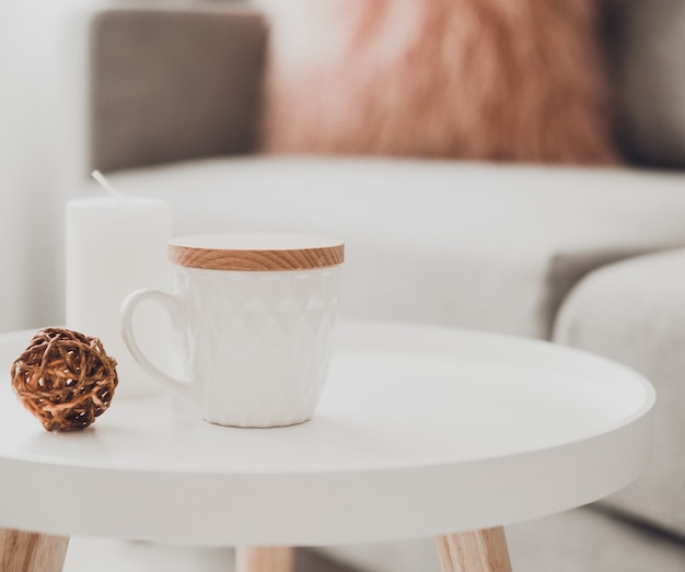 Cozy home decorations in the interior with cup of tea