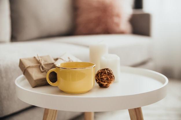 Cozy home decorations in the interior with cup of tea