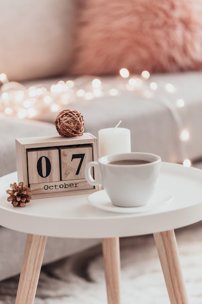 Cozy home decorations in the interior with cup of tea .