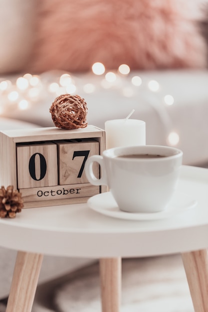 Cozy home decorations in the interior with cup of tea