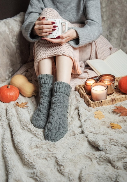 Photo cozy home woman covered with warm blanket drinks coffee