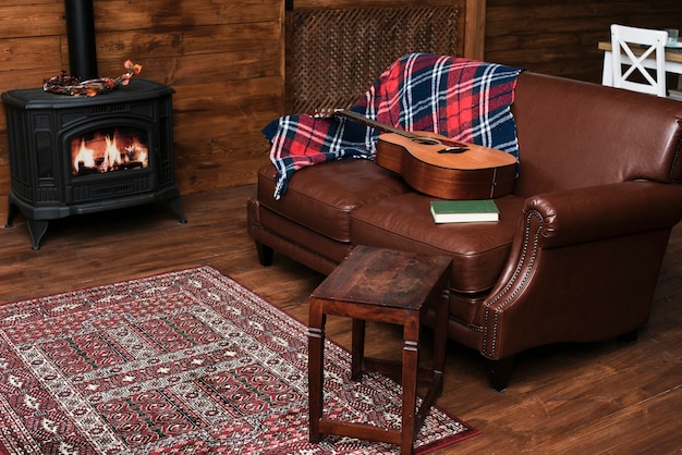 Cozy interior with guitar on the couch