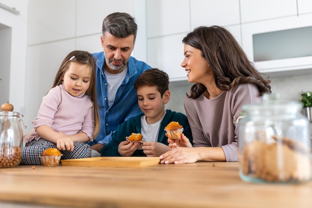 Photo in the cozy kitchen a family gathers around the table with smiles on their faces enjoying the simple pleasures of togetherness and sweetness in every bite