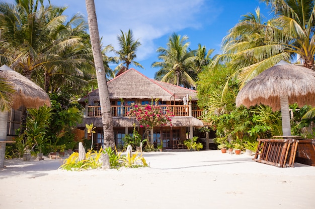 Cozy little hotel on a tropical exotic resort at white sandy beach