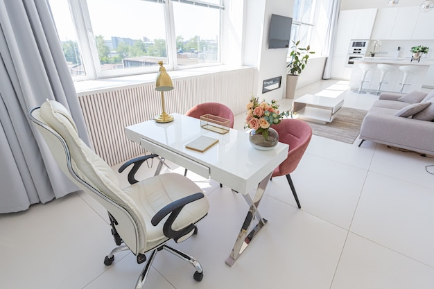 Cozy luxury modern interior design of a studio apartment in extra white colors with fashionable expensive furniture in a minimalist style.