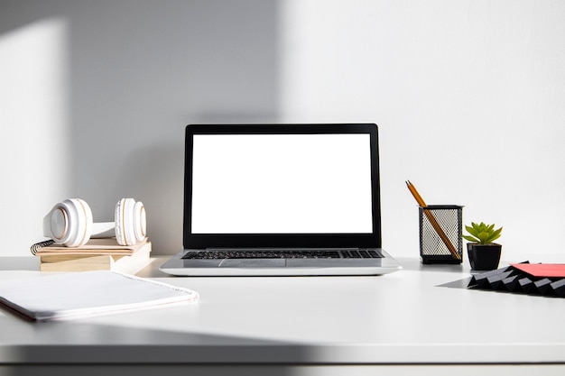 Cozy modern workspace with computer and office supplies near the window