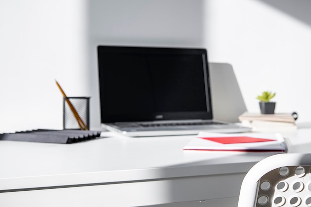 Cozy modern workspace with computer and office supplies near the window