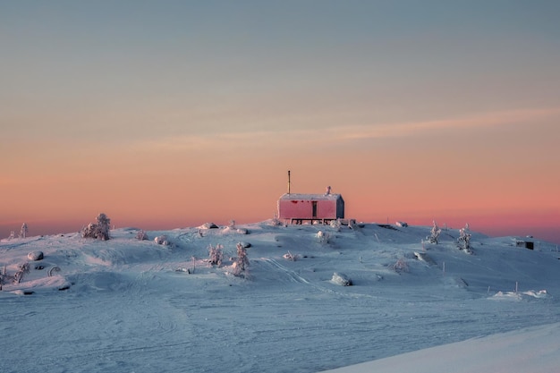 Cozy northern guest house on a snowy hill at dawn cabin in\
winter dawn lonely house on a hilltop in the cool morning