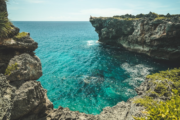 The cozy ocean bay surrounded by the cliffs. Sumba