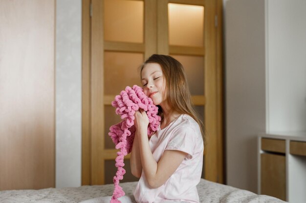 Cozy portrait of child girl with needlework at home