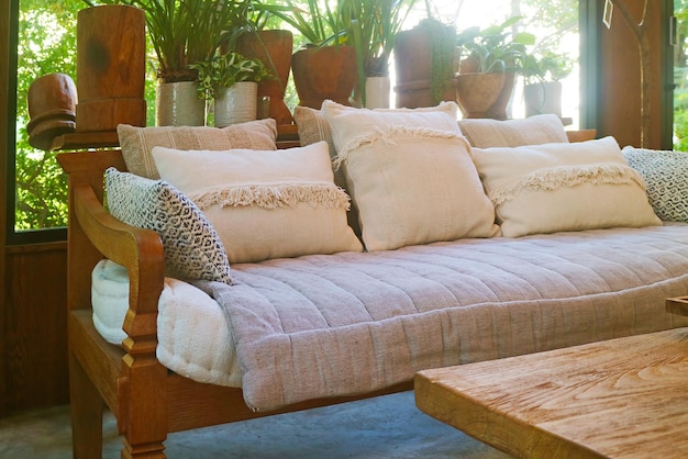 Cozy sofa with group of fluffy cushions in a living room