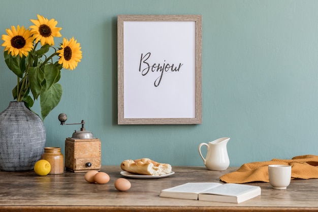 Cozy and stylish composition of creative dining room with frame, wooden consola, sunflowers and personal accessories.