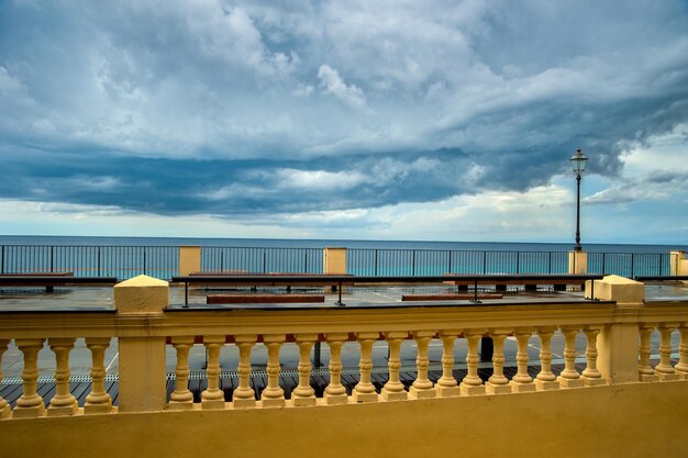 Cozy terrace on the embankment of the Mediterranean Sea with a beautiful sky