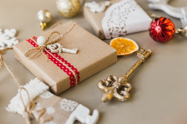 Cozy vintage toned winter holidays Christmas Composition with Gifts Boxes and Balls, Pine Cones Wooden Background. Styled photography for blog posts. Flat lay top view.