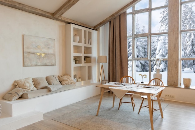 Cozy warm home interior of a chic country chalet with a huge panoramic window overlooking the winter forest open plan wood decoration warm colors and a family hearth