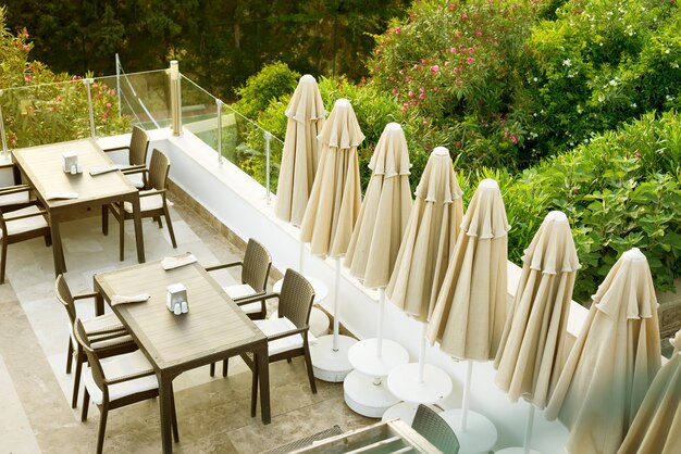 A cozy wicker table in the outdoor cafe-bar on the rooftop in the morning