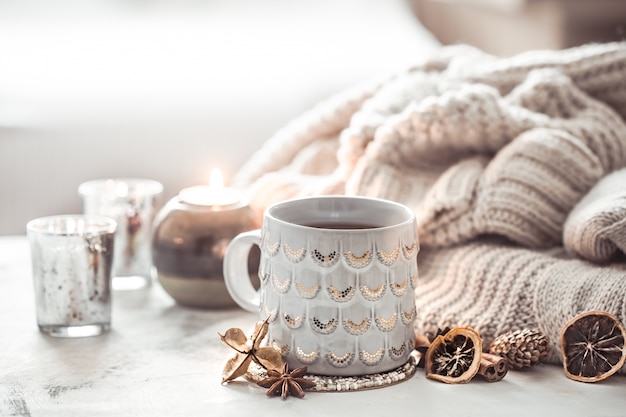 cozy winter composition with a cup and sweater