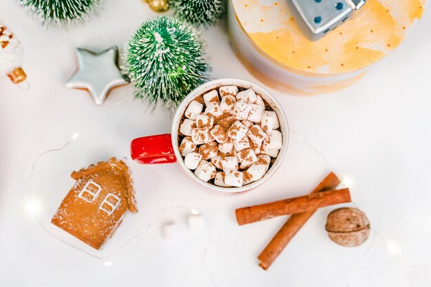 Cozy winter flat lay with a mug of cocoa with marshmallows Christmas decorations