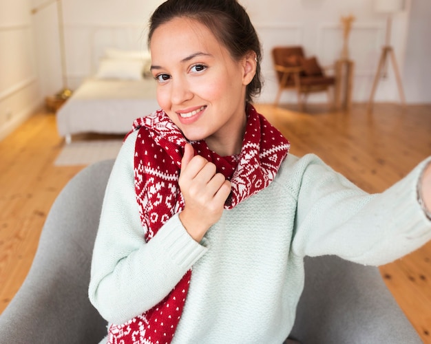 Photo cozy woman taking selfie with scarf