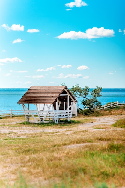 Photo cozy wooden picnic house on the seashore with a beautiful summer landscape with blue sky crimea