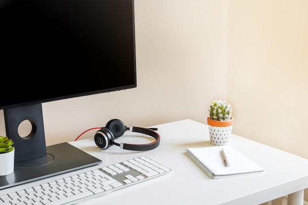 A cozy workplace with a monitor screen and keyboard.