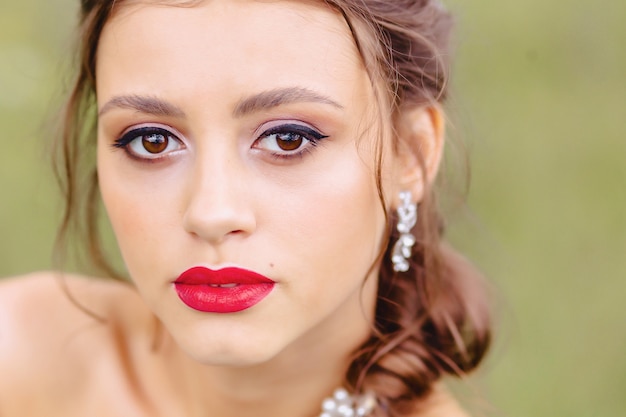 Cozy young girl with red lips closup