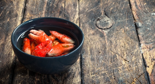 Crab in a bowl. On a wooden background.