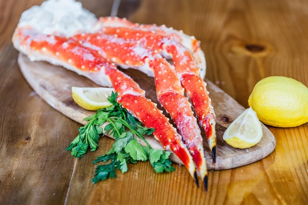 Crab claws on a cutting board.