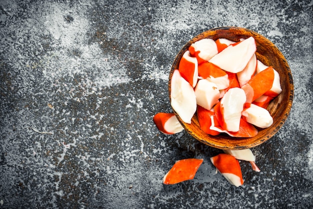 Crab meat in a bowl on a rustic table.