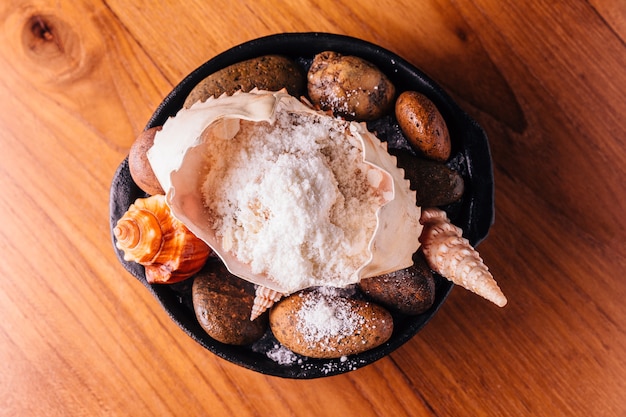 Crab mix with snow flake served in crab shell and decorated with sea stone and shell